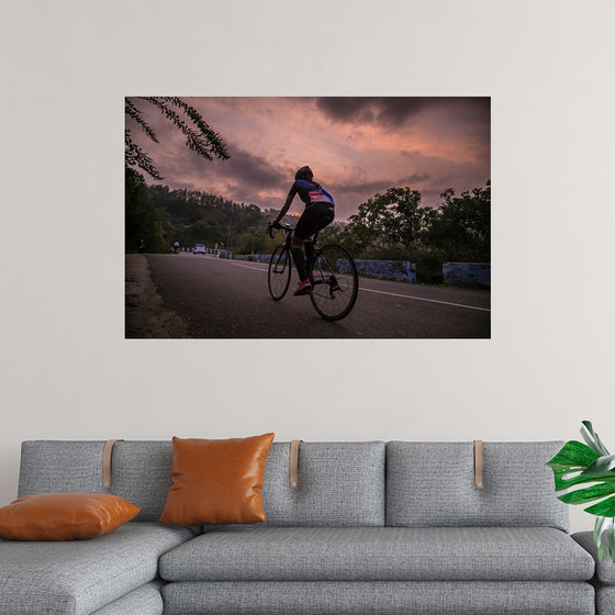 "Male bicycling along a treed road in Ooty"