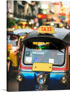 Immerse yourself in the vibrant and bustling streets with this exquisite print of a classic scene. The artwork captures a colorful taxi, its glossy exterior reflecting the lively atmosphere of the city around it. Every detail, from the iconic “TAXI” sign illuminated in bold letters to the blurred lights and signs in the background, invites you into a world where tradition meets modernity.