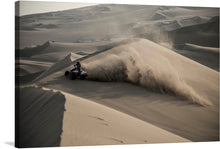  A lone rider, astride their powerful ATV, conquers the majestic dunes that stretch endlessly, painting a serene yet invigorating landscape. The dance of light and shadow accentuates the fluidity of the sands, evoking a sense of both motion and stillness.