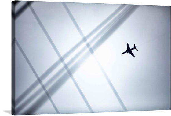  “Plane” by Royal Norwegian Navy. This artwork captures the majestic flight of a Royal Norwegian Navy aircraft. The silhouette of the plane, stark against a backdrop of intersecting contrails, evokes a sense of freedom and exploration. The minimalist design, marked by its soft hues and dynamic lines, seamlessly blends with various interior styles.