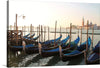  The artwork captures a tranquil morning, where gondolas gently rock on the calm waters, tethered to their posts, awaiting the day’s adventures. The iconic architecture of Venice looms in the background, bathed in the soft glow of dawn.