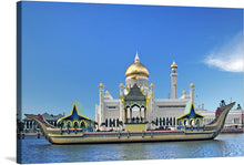  Immerse yourself in the serene beauty of this exquisite print capturing the iconic Sultan Omar Ali Saifuddien Mosque, a symbol of Brunei’s rich cultural heritage. The artwork encapsulates the mosque’s majestic presence, with its golden dome gleaming under the azure sky, reflecting off the tranquil waters surrounding it. Traditional boats adorn the foreground, adding a touch of historical elegance. 