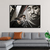 "Man With Dreadlocks and Sunglasses Poses Near Tupac Shakur Portrait"