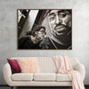 "Man With Dreadlocks and Sunglasses Poses Near Tupac Shakur Portrait"