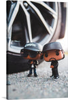 This captivating print, titled “Icons of the Era”, brings to life two iconic figures immortalized as stylized miniatures. Set against the backdrop of an intricate alloy wheel, these figures exude an aura of coolness and nostalgia. One figure, donning sunglasses and a cap marked “Compton,” evokes the legendary West Coast hip-hop scene. The other, dressed in black, mirrors the intensity and passion that defined an era.