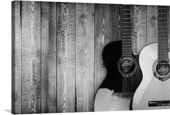 Immerse yourself in the soul-stirring resonance of this exquisite artwork. The print encapsulates the silent symphony of two guitars resting against a rustic wooden backdrop. The monochromatic tones weave a narrative of timeless elegance, where every grain and groove tells a story. The contrasting silhouettes of the guitars - one dark and enigmatic, the other light and graceful - evoke an unspoken harmony. 