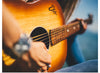 "Person Play Guitar in Close-up Photo"