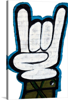  Introducing our exclusive print, a vibrant and dynamic piece of art that captures the universal symbol of peace and victory. This artwork, featuring a hand gesturing the iconic sign, is painted against a textured brick wall backdrop, giving it an urban and contemporary edge. The bold outlines and striking contrasts between the white hand and deep blue shadows make this piece a statement of optimism and unity. 