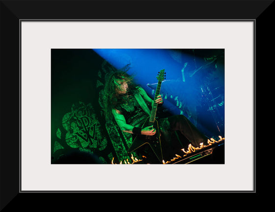 "Person Playing Guitar on Stage With Light Ray", Thibault Trillet