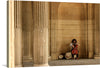 “Street Performer, Cello” invites you into a mesmerizing world where music and architecture harmonize. This captivating print captures a cellist in the midst of performance, their passion resonating through each stroke of the bow. Against a backdrop of grand columns, the musician’s focused expression contrasts with the stoic surroundings, creating a visual symphony. 