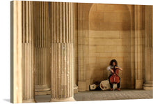  “Street Performer, Cello” invites you into a mesmerizing world where music and architecture harmonize. This captivating print captures a cellist in the midst of performance, their passion resonating through each stroke of the bow. Against a backdrop of grand columns, the musician’s focused expression contrasts with the stoic surroundings, creating a visual symphony. 