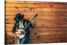  This captivating print transports you to the heart of the old west, where the soulful twang of a banjo resonates through the rugged landscape. The photo-realistic image features a musician, clad in a black cowboy hat and vest, strumming the strings of a weathered 5-string banjo.