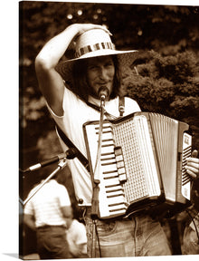  Immerse yourself in the nostalgic allure of this captivating artwork, capturing a passionate accordion player lost in the melody. The sepia tones evoke a sense of timeless elegance, transporting you to a serene, musical moment frozen in time. Every detail, from the rustic straw hat shading the musician’s face to the intricate design of the accordion, is meticulously captured to breathe life and emotion into your space.