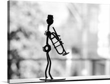  Immerse yourself in the soul-stirring echoes of jazz with this exquisite print capturing a silhouette of a wire sculpture musician, lost in the harmonious melodies of his trumpet. The monochromatic tones accentuate the artist’s slender form, casting an enigmatic shadow that dances to the rhythm of silent tunes. 