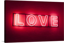  “Love Light” is a captivating artwork that embodies the essence of affection and warmth. The word “LOVE” is illuminated in bright pinkish-red neon lighting, casting a soft glow against the deep red background.