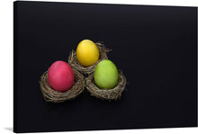  “Easter Eggs Nest” is a beautiful print that would make a great addition to any home. The print features three colorful Easter eggs nestled in small nests against a black background. The contrast between the bright colors of the eggs and the dark background make the image pop, creating a striking piece of art.