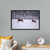 "Two white-tailed deer run through the snow"