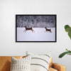 "Two white-tailed deer run through the snow"