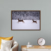 "Two white-tailed deer run through the snow"