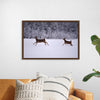 "Two white-tailed deer run through the snow"