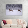 "Two white-tailed deer run through the snow"