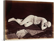   This exquisite print brings to life the echoes of Pompeii’s past, showcasing a human cast that tells a story of life interrupted. The intricate details and emotional resonance of the figure, lying prone on the ground with one arm extended forward, make this artwork not just a piece but a conversation starter.