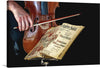 “Violinist” by William Michael Harnett is a captivating canvas print that transports viewers into the soulful world of music. The image captures a close-up view of a violinist, their hands gracefully coaxing melodies from the instrument. The violin’s rich brown hues contrast beautifully with the aged sheet music, its intricate details hinting at timeless compositions. 