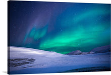  This captivating print titled “Northern Lights” is a stunning tribute to the natural phenomenon that illuminates the night sky in the polar regions. The artwork captures a breathtaking view of the Northern Lights displaying vibrant green and blue hues against a starry night sky. A snowy landscape stretches out beneath this celestial display, with rolling hills and valleys covered in white snow. 