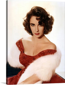  This elegant and glamorous print of Elizabeth Taylor is a must-have for any fan of Hollywood, fashion, or beauty. Taylor is depicted in a close-up view, with her piercing blue eyes and iconic violet lips.