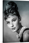 This iconic black and white photograph of Audrey Hepburn as Holly Golightly in Breakfast at Tiffany's is a must-have for any fan of classic cinema or timeless beauty. The image captures Hepburn at her most elegant and sophisticated, with her signature hairstyle and little black dress. Her gaze is both wistful and hopeful, reflecting the complex and intriguing character of Holly Golightly.