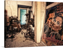  “Casablanca Poster in Room” is a unique and engaging piece of art. The print features a vintage poster of the classic film “Casablanca” in a room with an antique sewing machine and other interesting objects. 