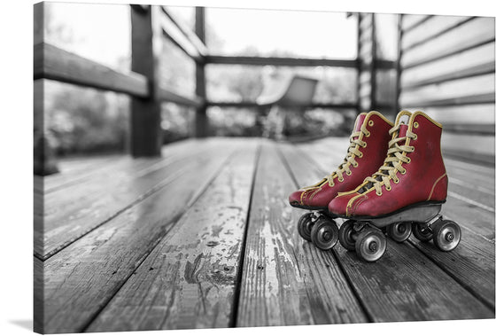 Introducing “Roller Skates,” a captivating artwork that encapsulates the essence of nostalgic freedom and youthful exuberance. This exquisite print features a pair of vintage red roller skates, vivid against a monochromatic backdrop, evoking a powerful contrast that breathes life and emotion into any space. The skates, adorned with golden laces, rest gracefully on an aged wooden floor, inviting viewers into a world where the simplicity and joy of childhood reign supreme. 