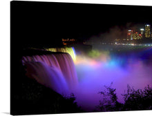  This exquisite print, “Niagara Falls Dancing Lights” by Jean Beaufort, captures the iconic waterfall, bathed in a symphony of colors that dance across the cascading waters, creating a visual spectacle that breathes life and energy into any space. The distant city lights twinkle like stars, casting a serene glow that contrasts beautifully with the vibrant illumination of the falls. 
