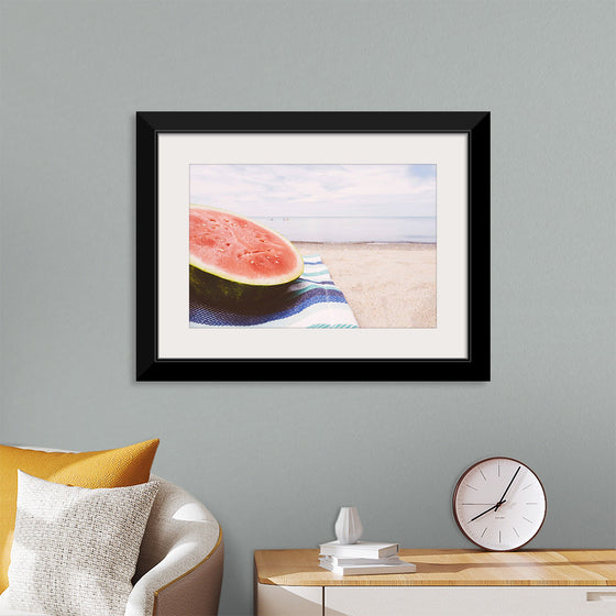 "Half of a watermelon on the beach"