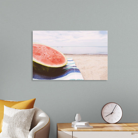 "Half of a watermelon on the beach"