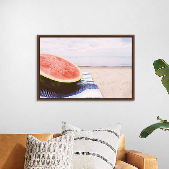 "Half of a watermelon on the beach"