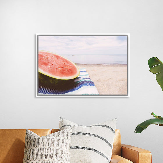 "Half of a watermelon on the beach"