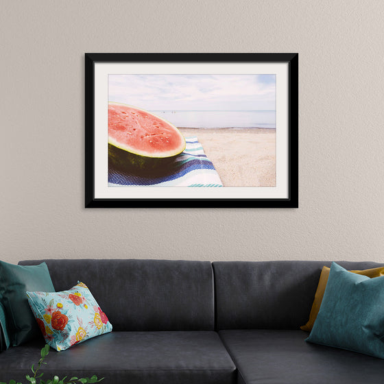 "Half of a watermelon on the beach"