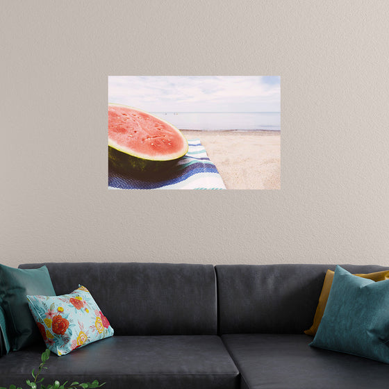 "Half of a watermelon on the beach"