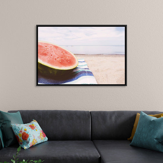 "Half of a watermelon on the beach"