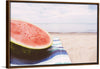 "Half of a watermelon on the beach"