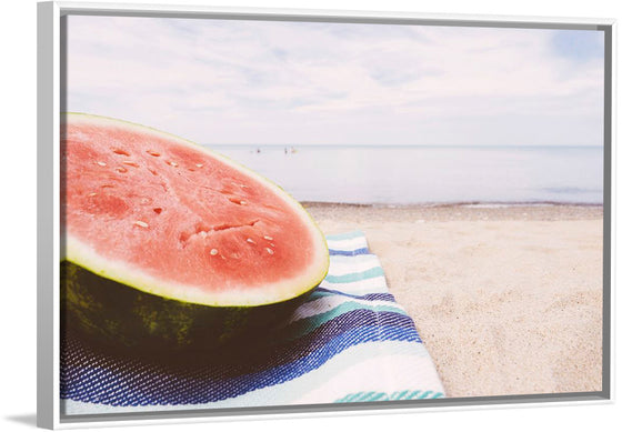 "Half of a watermelon on the beach"