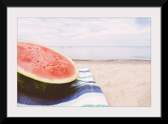 "Half of a watermelon on the beach"