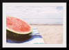 "Half of a watermelon on the beach"