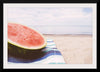 "Half of a watermelon on the beach"