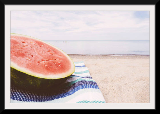 "Half of a watermelon on the beach"