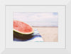 "Half of a watermelon on the beach"