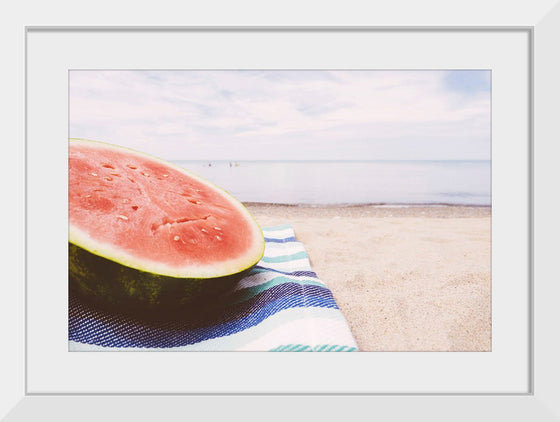 "Half of a watermelon on the beach"