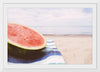 "Half of a watermelon on the beach"