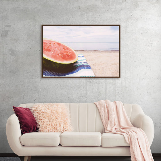 "Half of a watermelon on the beach"